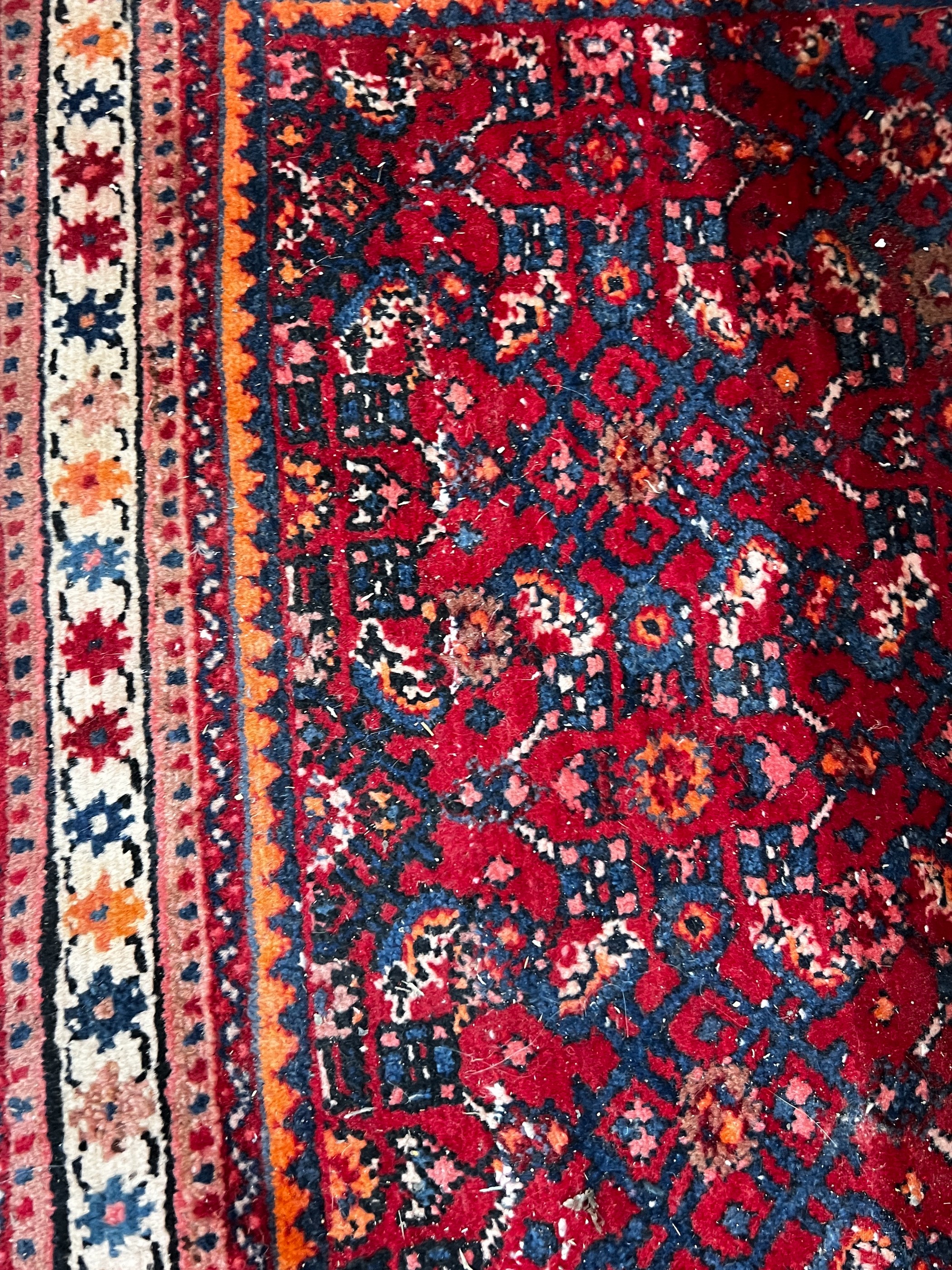 A North West Persian red ground rug, 164 x 105cm